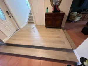 Raised entry platform with new vinyl plank flooring installed in Miami residential renovation