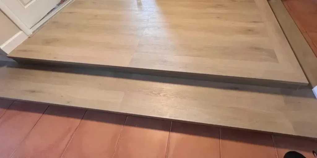 Raised entry platform with new vinyl plank flooring installed in Miami residential renovation