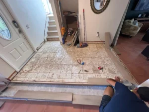 Old tiled entryway before raised vinyl flooring installation in Miami home
