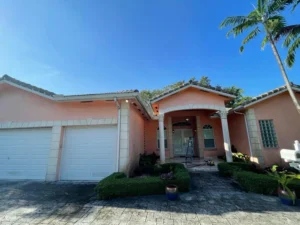 Faded peach house exterior before painting in Miami