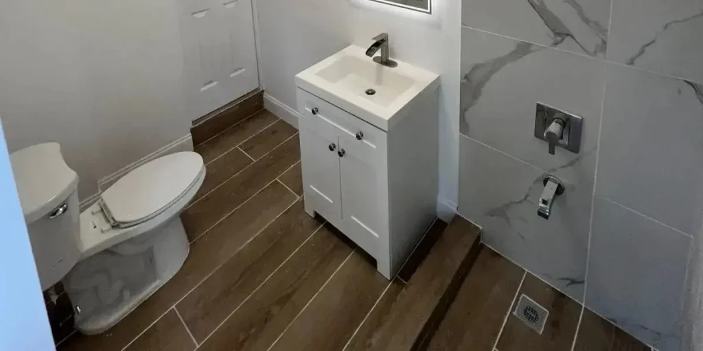 Completed new bathroom with shower and vanity built from laundry space in Miami