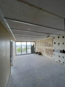 Living room before drywall and flooring installation in apartment renovation - Miami